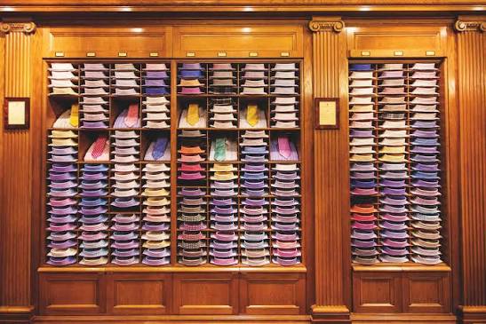 Wooden shelves filled with folded shirts